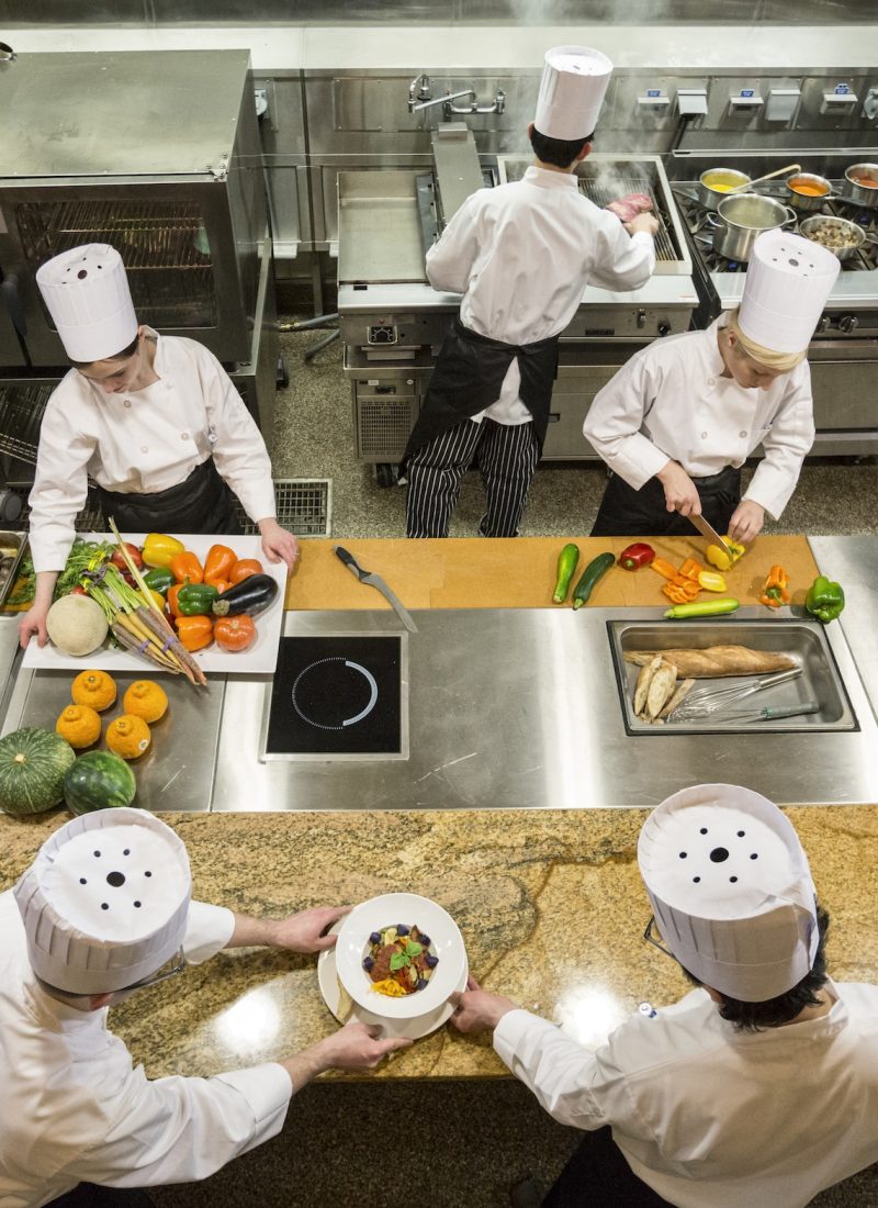 a-view-looking-down-on-a-crew-of-chefs-working-in-a-commercial-kitchen-.jpg